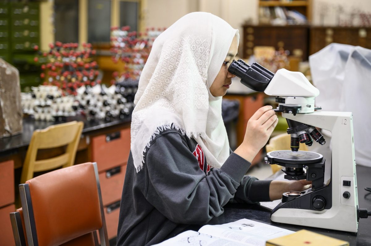 Student looking through a microscope
