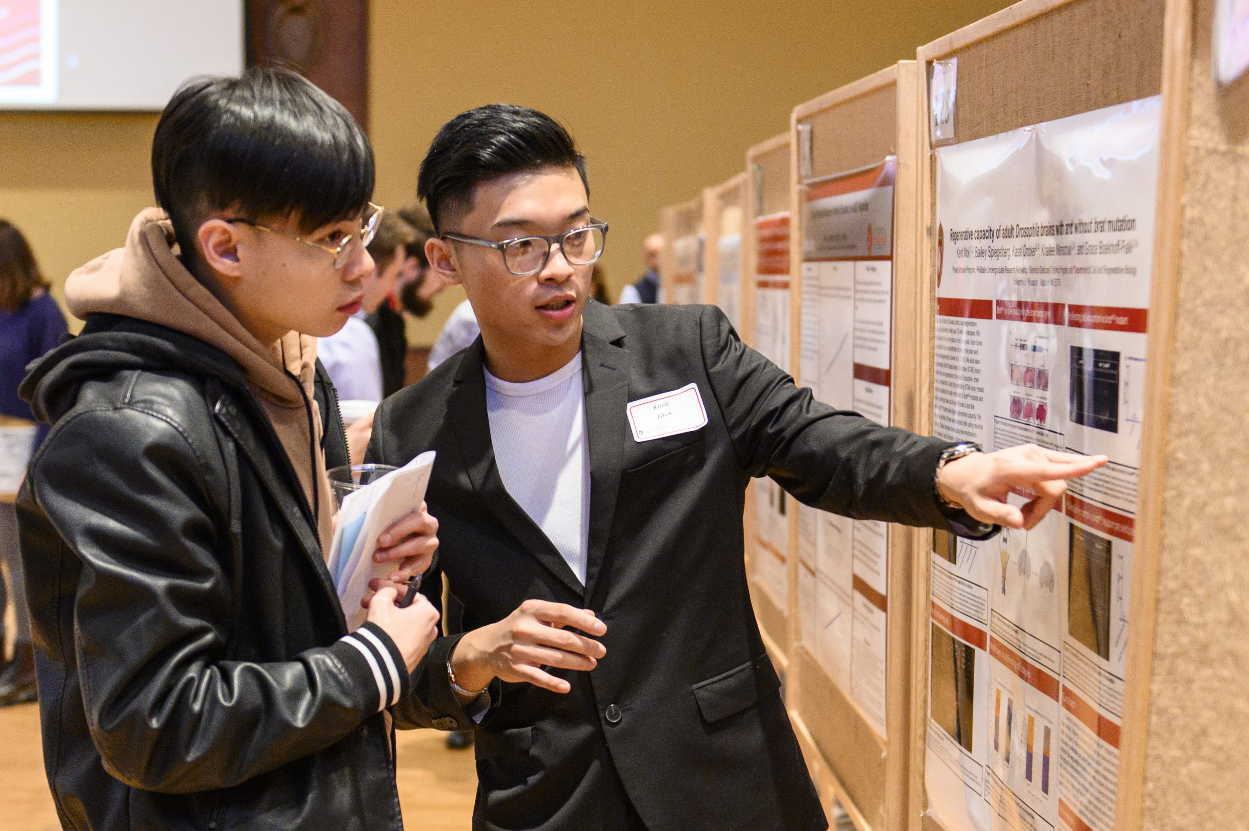 Students talking about a research poster