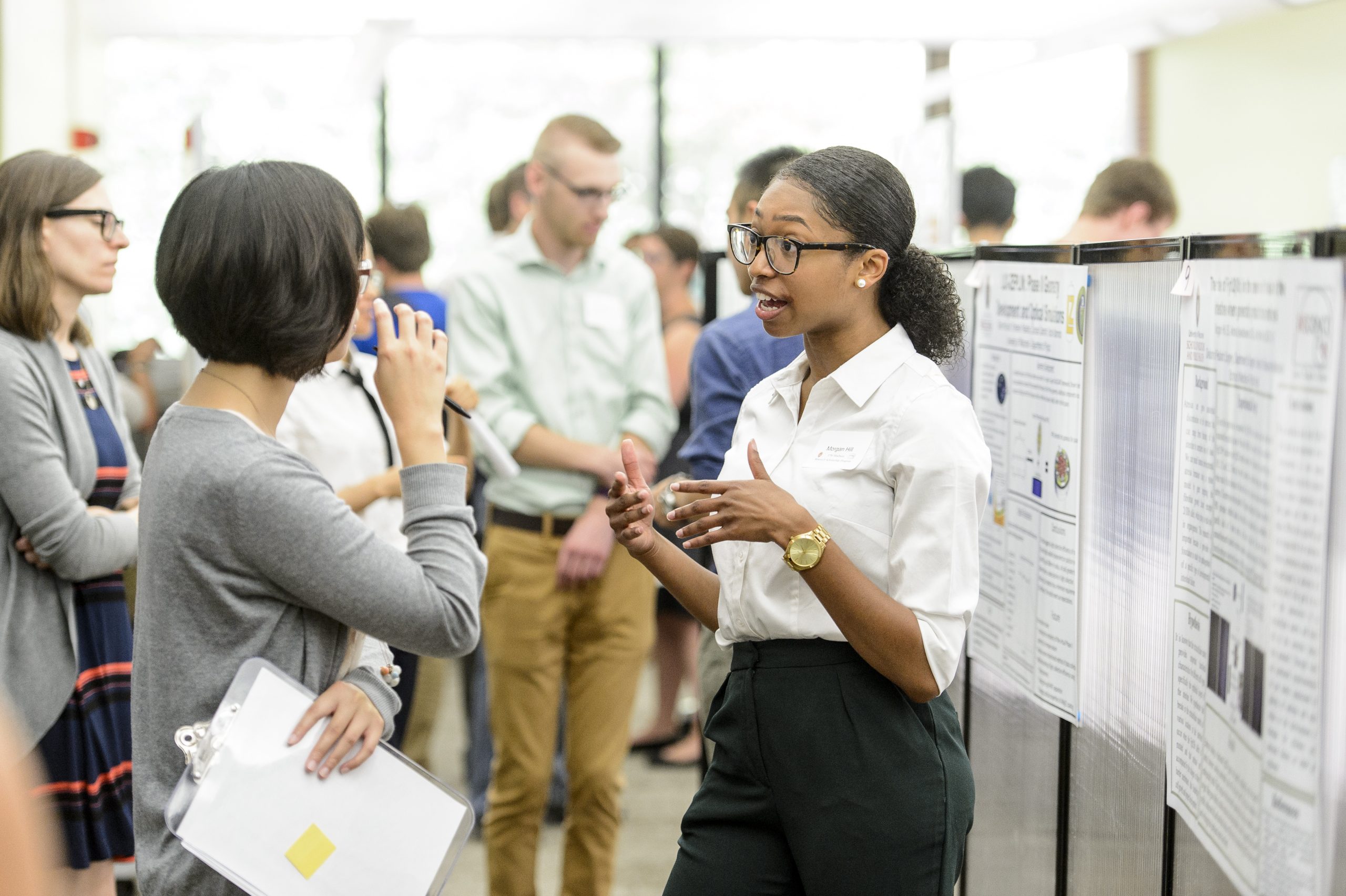 student presenting research poster