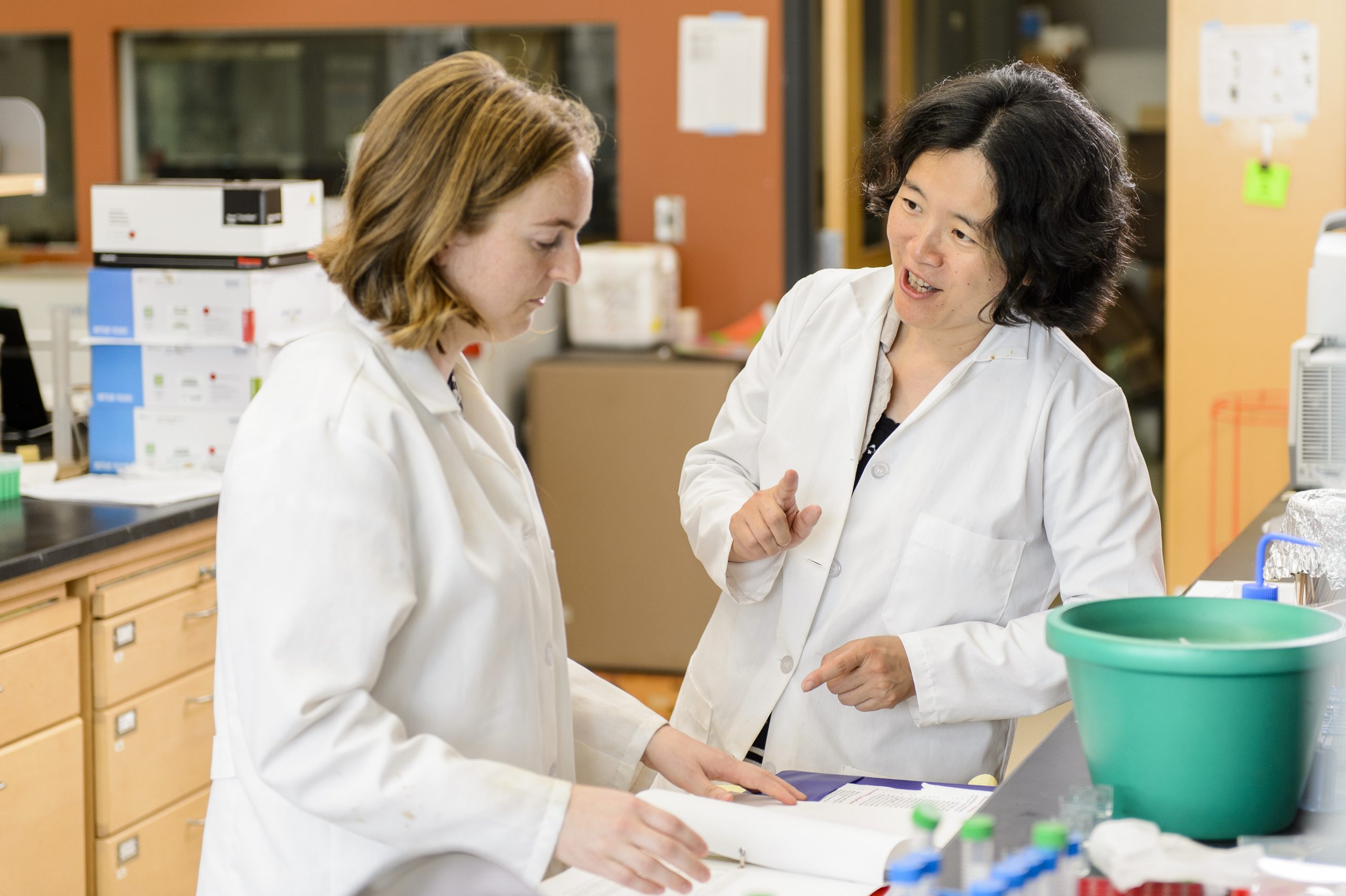 Professor and student talking in lab